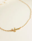 14K gold-filled personalized cross necklace engraved with the name Katlyn displayed on white background