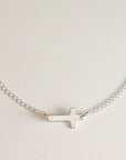 Sterling silver personalized cross necklace with blank engraving space on white background