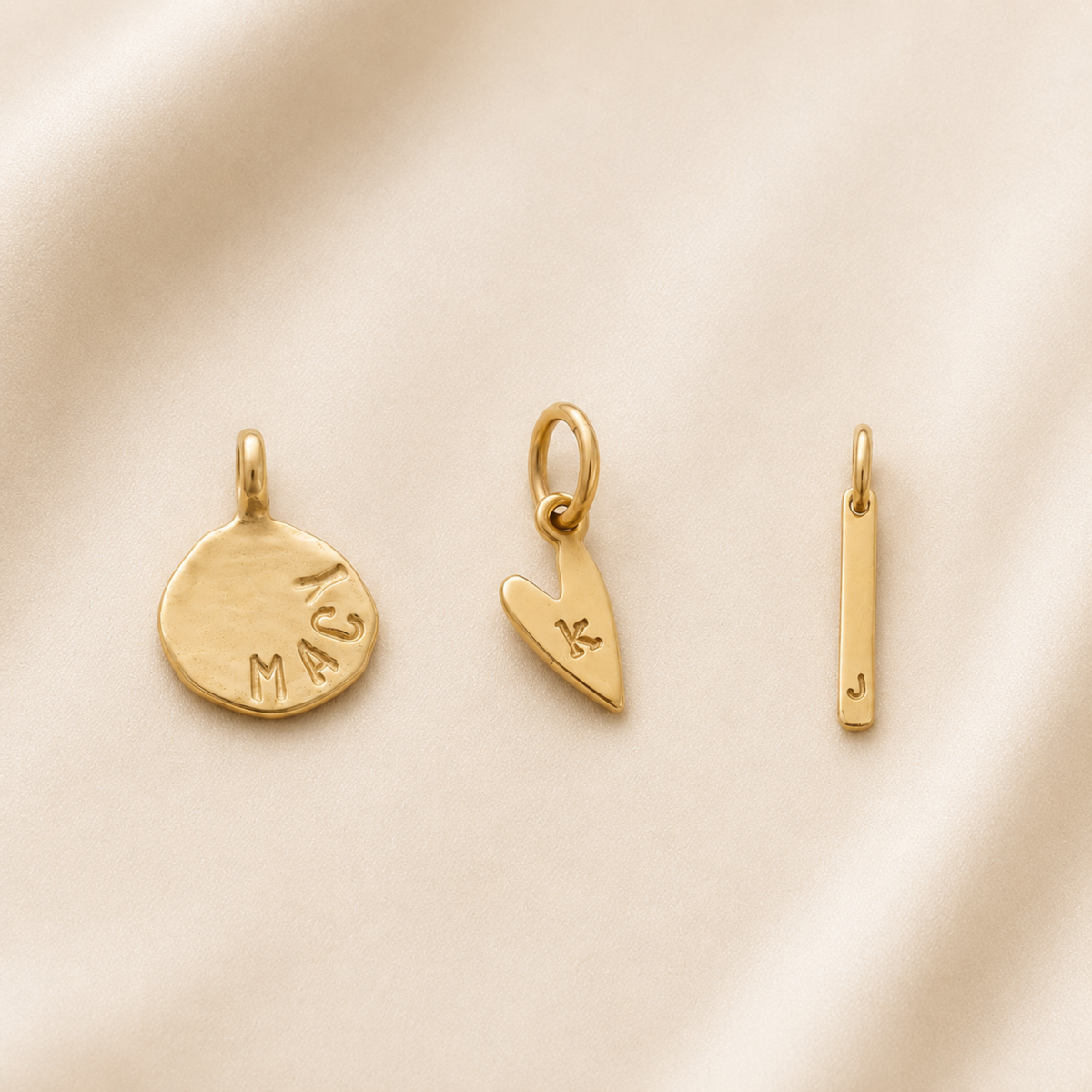 Dainty hand-stamped charm in gold vermeil with personalized initial on a bracelet accessory