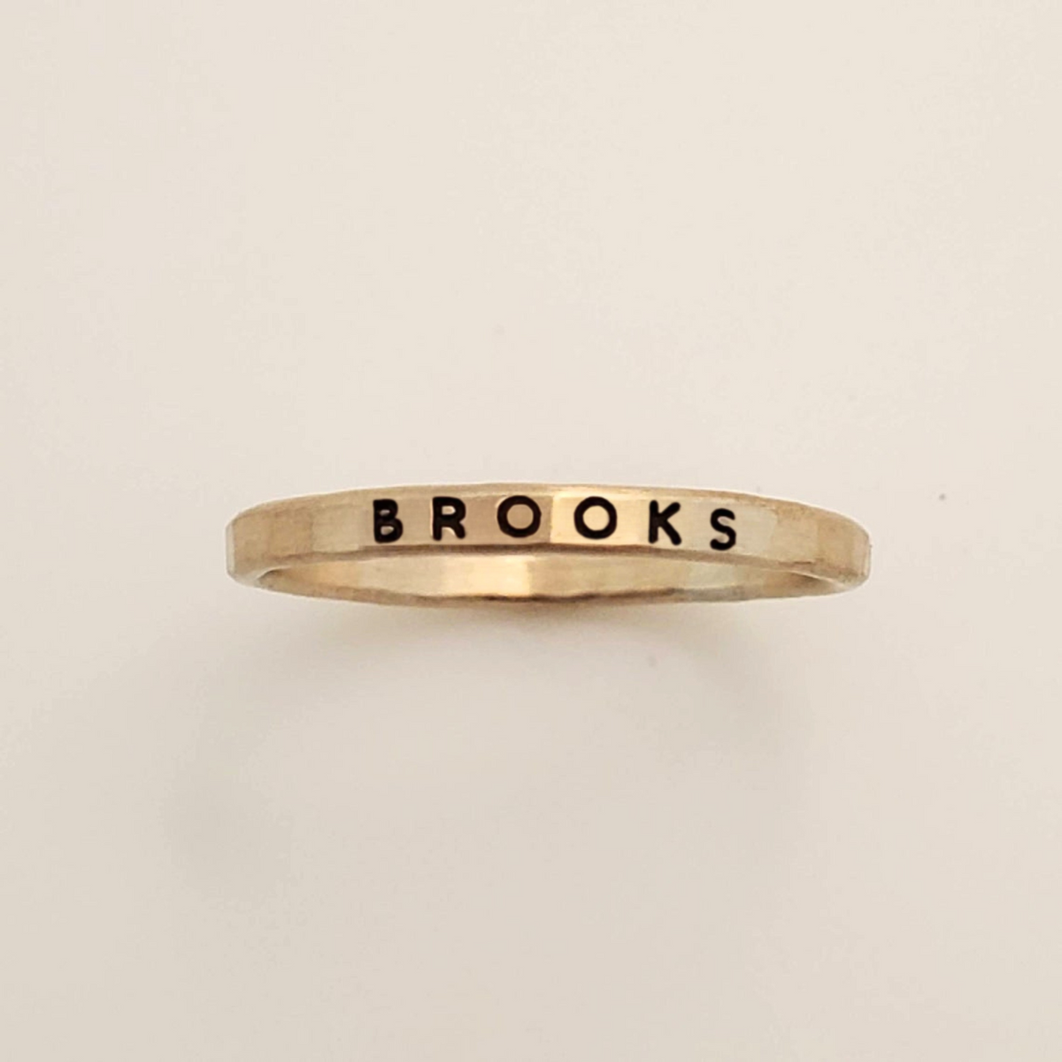 Bold Upper Stacking Name Ring with thick uppercase font on 2mm gold band, waterproof and tarnish-resistant