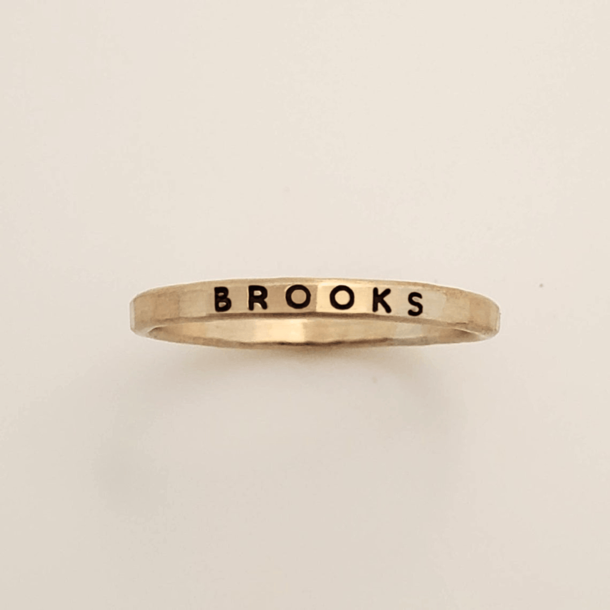 Bold Upper Stacking Name Ring with thick uppercase font on 2mm gold band, waterproof and tarnish-resistant