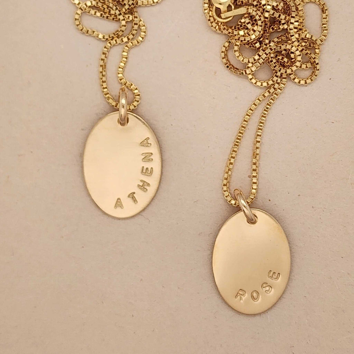 Personalized oval name necklace with engraved gold pendant in sterling silver, rose gold, and yellow gold finishes