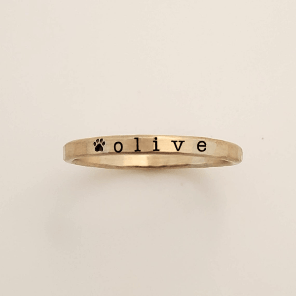 Custom pet name ring featuring pet's name and paw print in silver and gold options