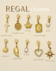 Collection of gold charms with labels on a beige background, featuring the brand 'Regal'.