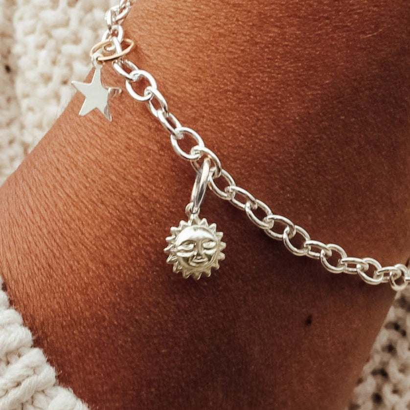 Silver charm bracelet in polished .925 sterling silver with classic charm design and secure clasp