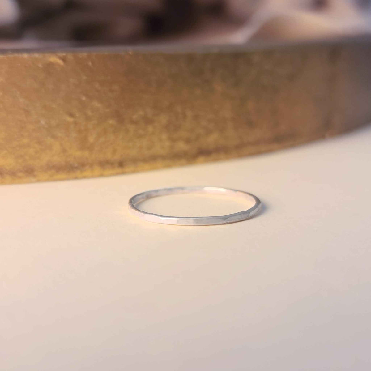 Thin silver ring on a light background