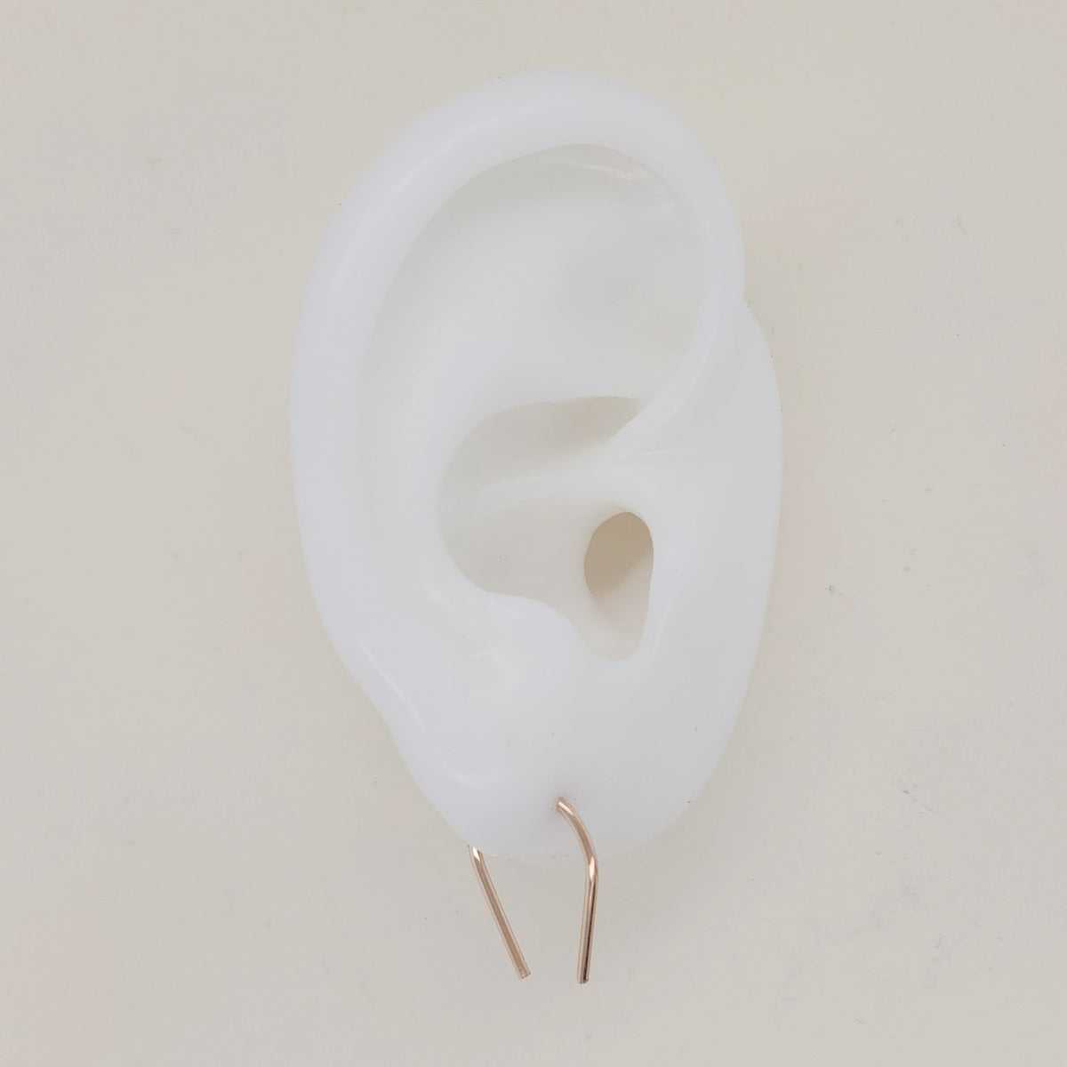 U-shaped earrings shown on white silicone ear display