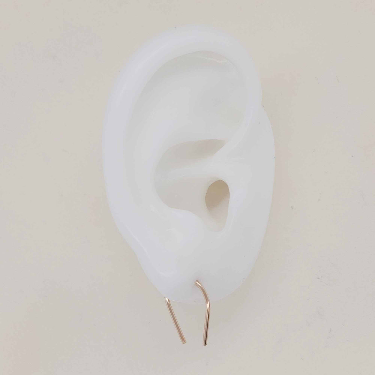 U-shaped earrings shown on white silicone ear display