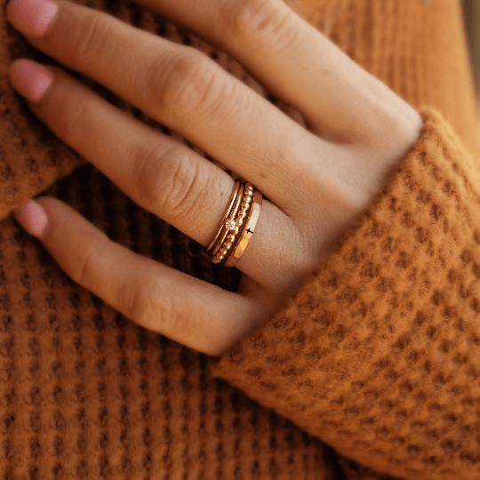 four delicate gold filled rings with a cross and cz stone.