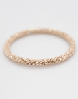 a yellow gold filled sparkle ring on a white background