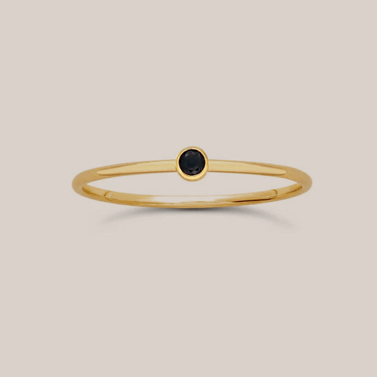 14K yellow gold filled black gemstone ring with a slender band and small black cubic zirconia stone