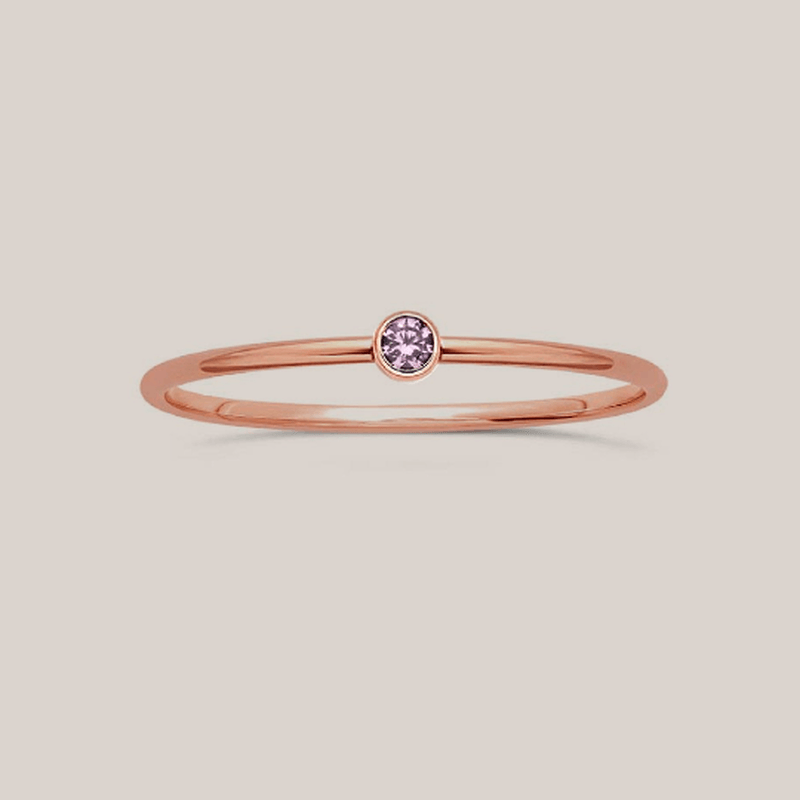Delicate rose gold June birthstone ring with a small lavender crystal, minimalist stacking design