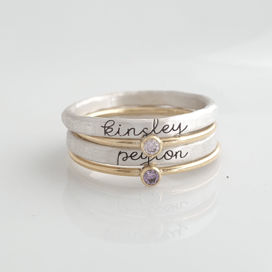 Willow Stacking Name Ring Set with personalized silver name rings and gold birthstone rings in cursive font