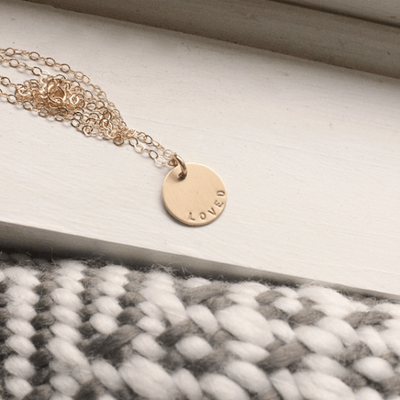 Gold-filled hand-stamped Loved Necklace pendant on chain with natural undarkened letters