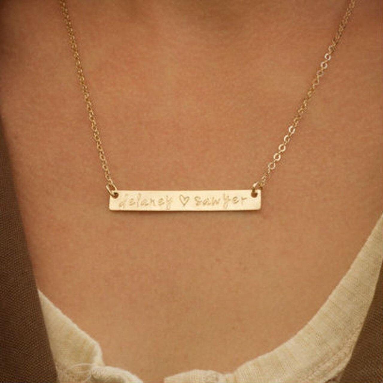 Gold bar necklace with "Delaney ♥ Sawyer" engraving