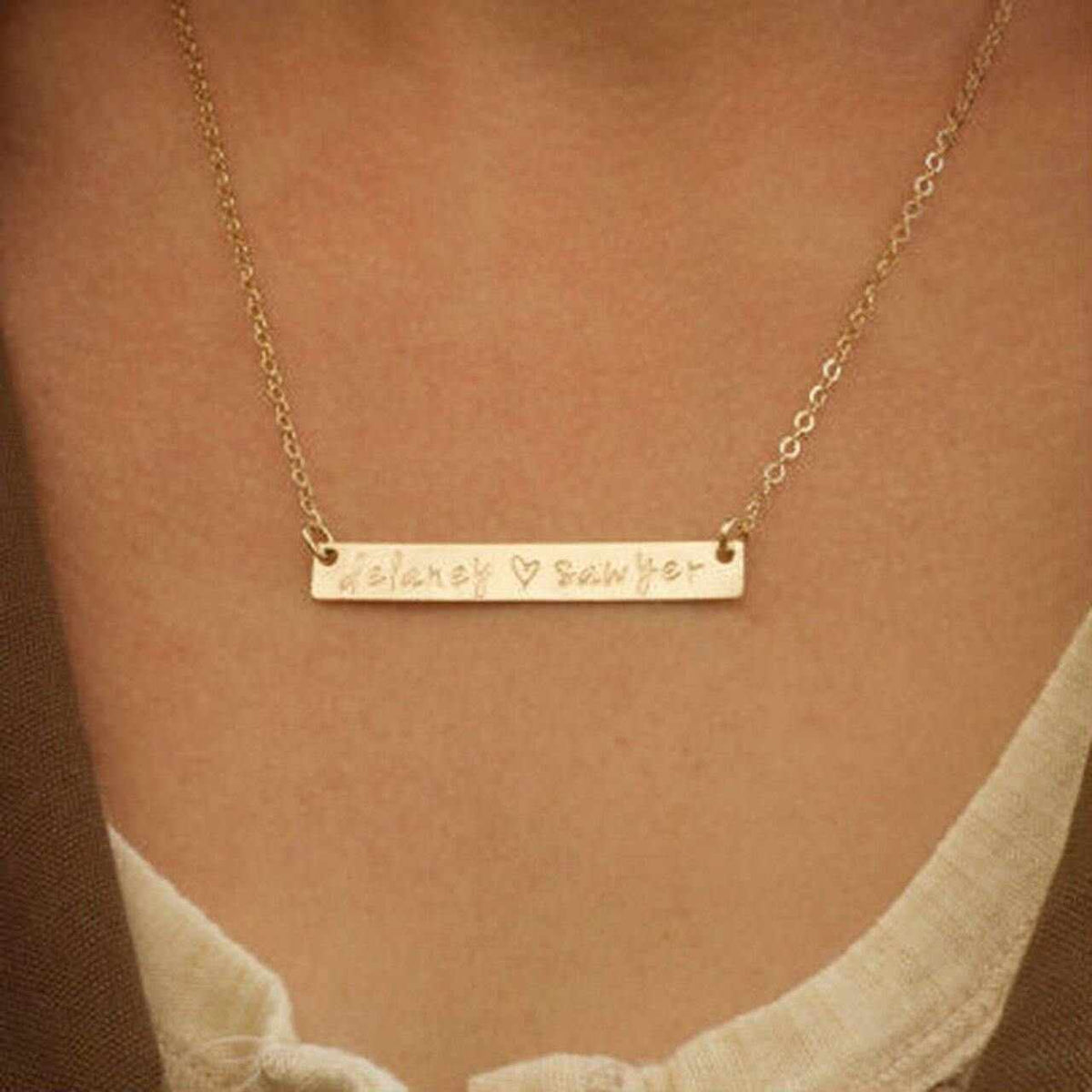 Gold bar necklace with "Delaney ♥ Sawyer" engraving