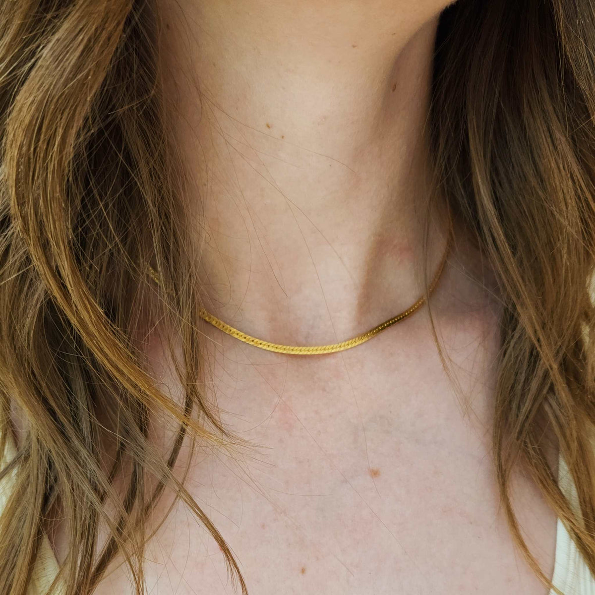 Close-up of elegant 14k gold filled and sterling silver layering chains from classic jewelry collection