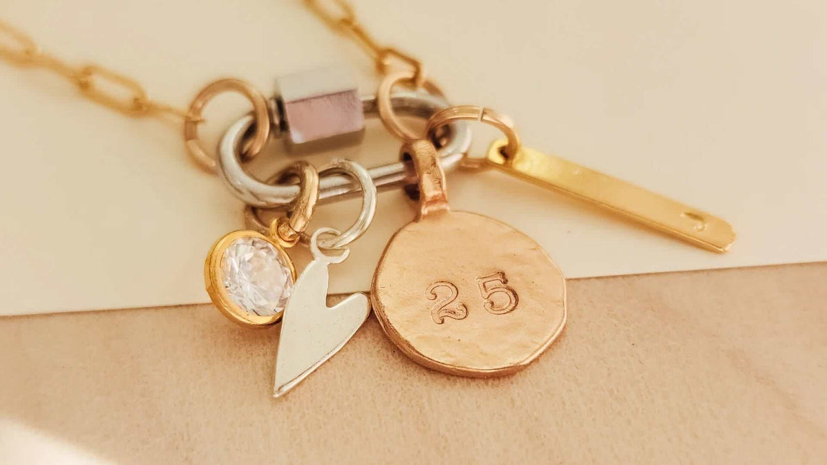 Close-up of a gold custom engraved necklace on a white background showcasing personalized handcrafted jewelry design