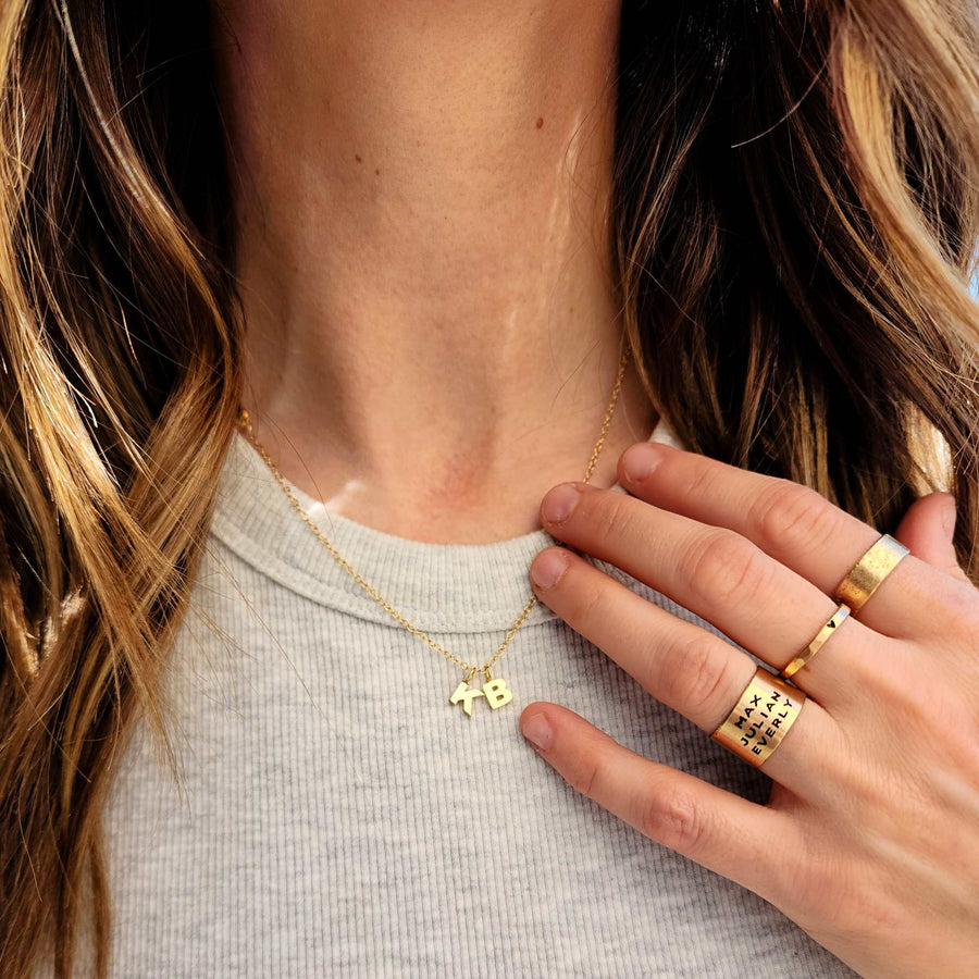 close-up of gold jewelry pieces showcasing solid gold, gold-filled, and PVD plated options