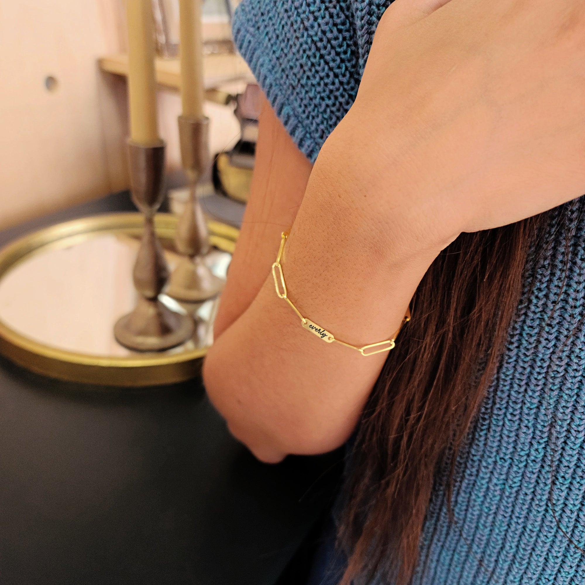 Model wearing 14K solid gold engravable bracelet while washing hands to show everyday use