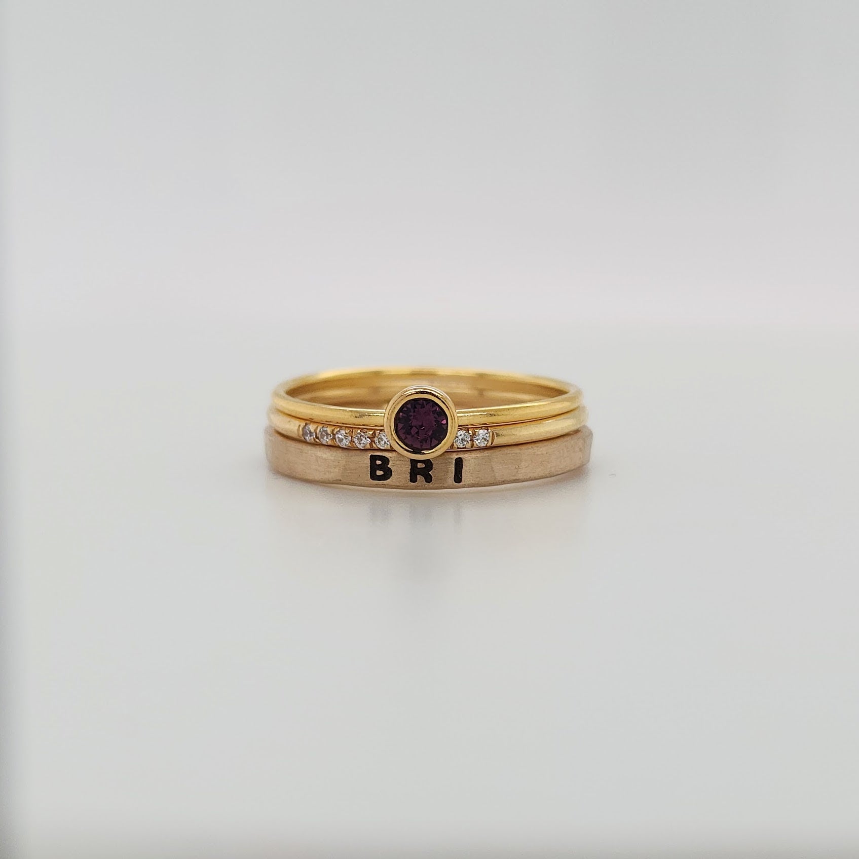 Large February Birthstone Ring stacked on two other rings