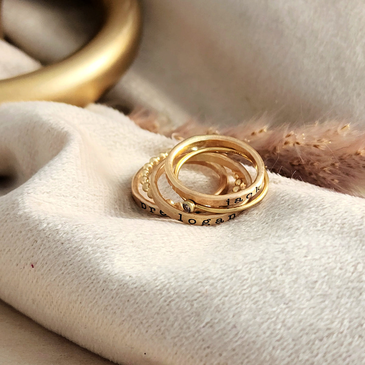 three personalized name rings engraved in our typewriter font, one beaded ring, one birthstone ring