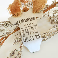 Personalized baby stats ornament with engraved name and birth details on wood
