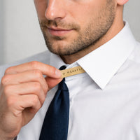 Man adjusting collar stay with name McKayla