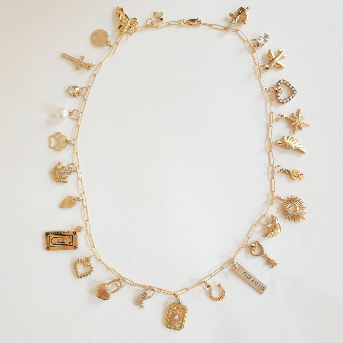 Custom necklace made with 18k gold plated PVD add-on charms in a full charm stack layout