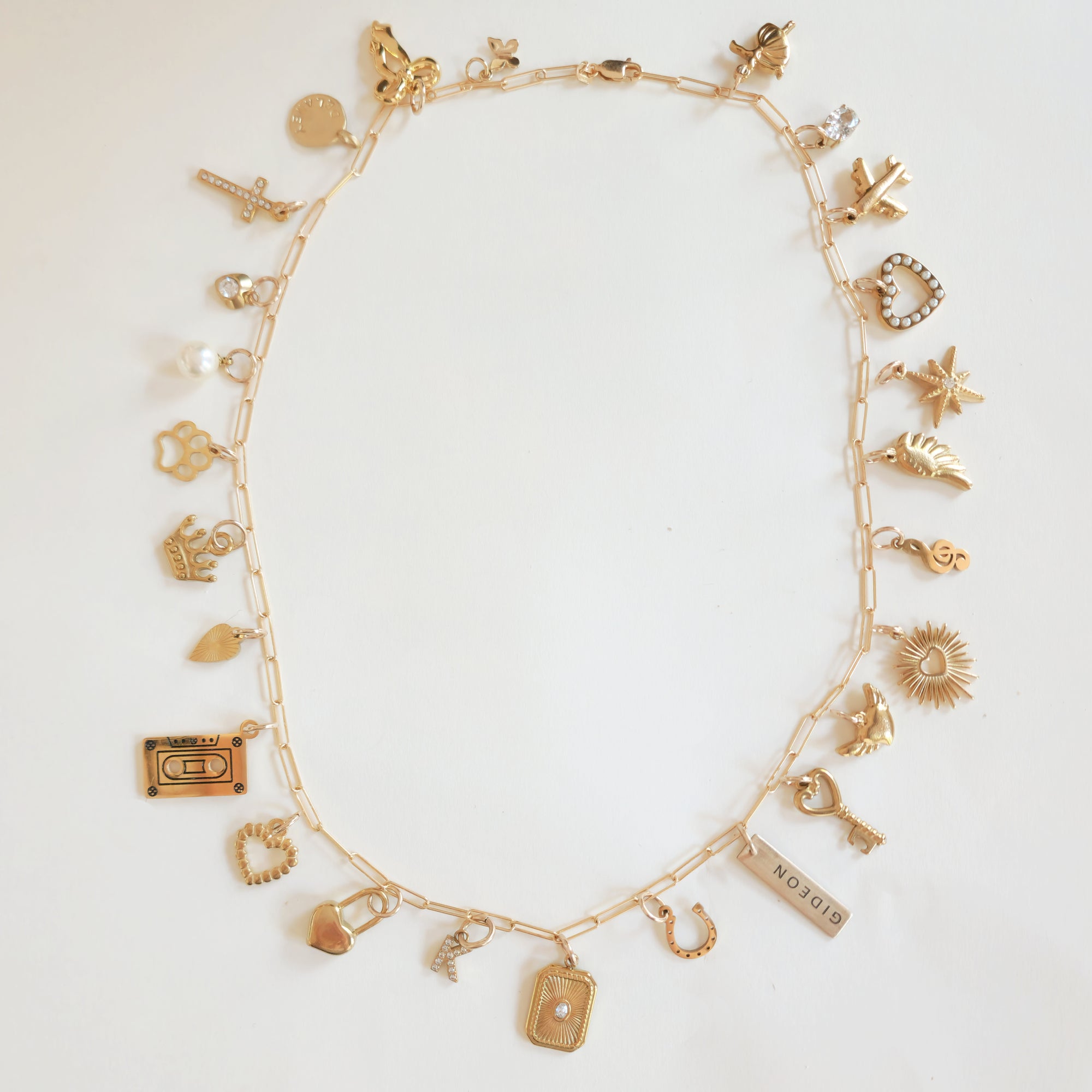 Custom necklace made with 18k gold plated PVD add-on charms in a full charm stack layout