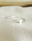 Suggestion


A silver colored mini heart ring placed on a white fabric surface.

