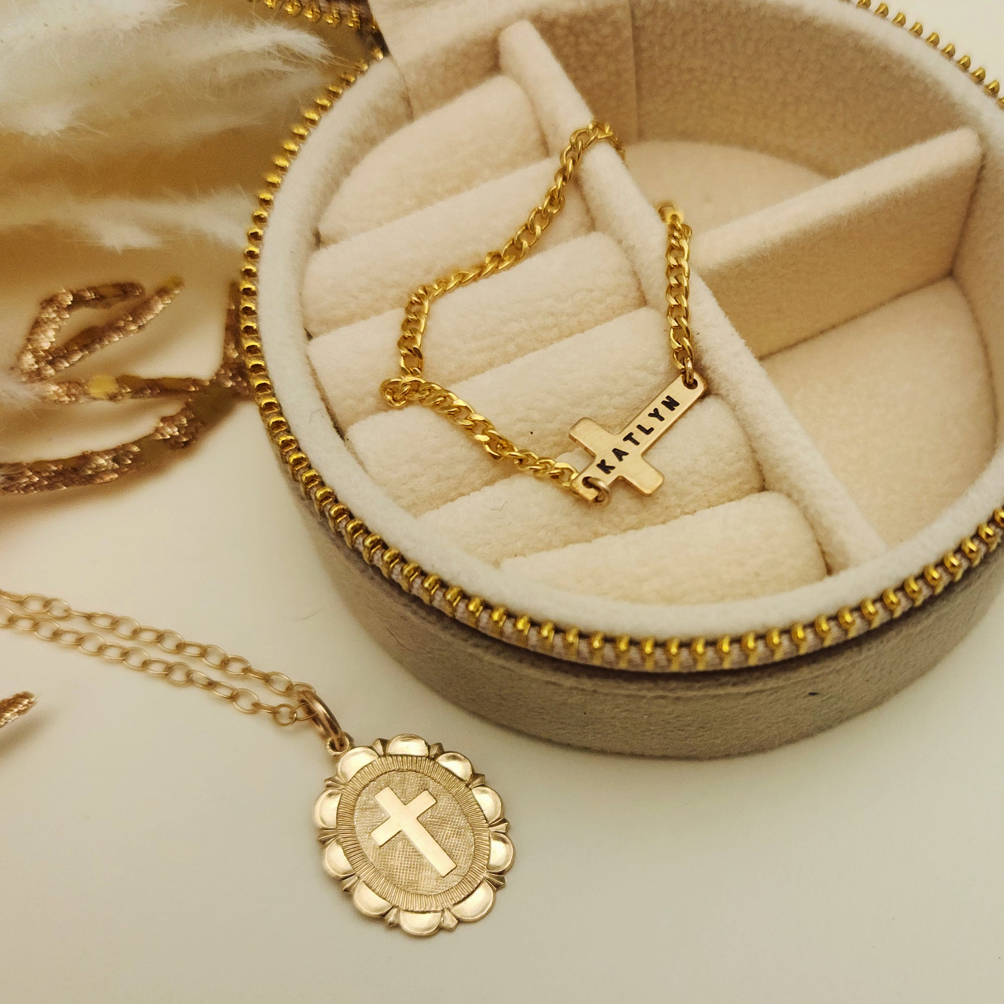 Gold necklaces with pendants on a beige jewelry box