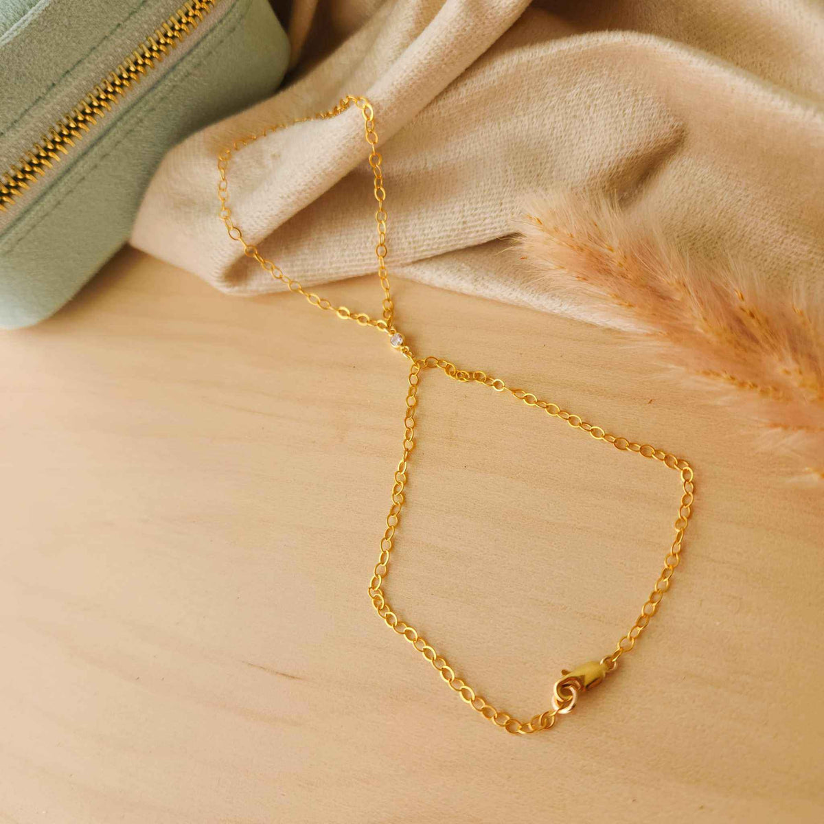 gold-filled and sterling silver hand chain bracelet on wrist