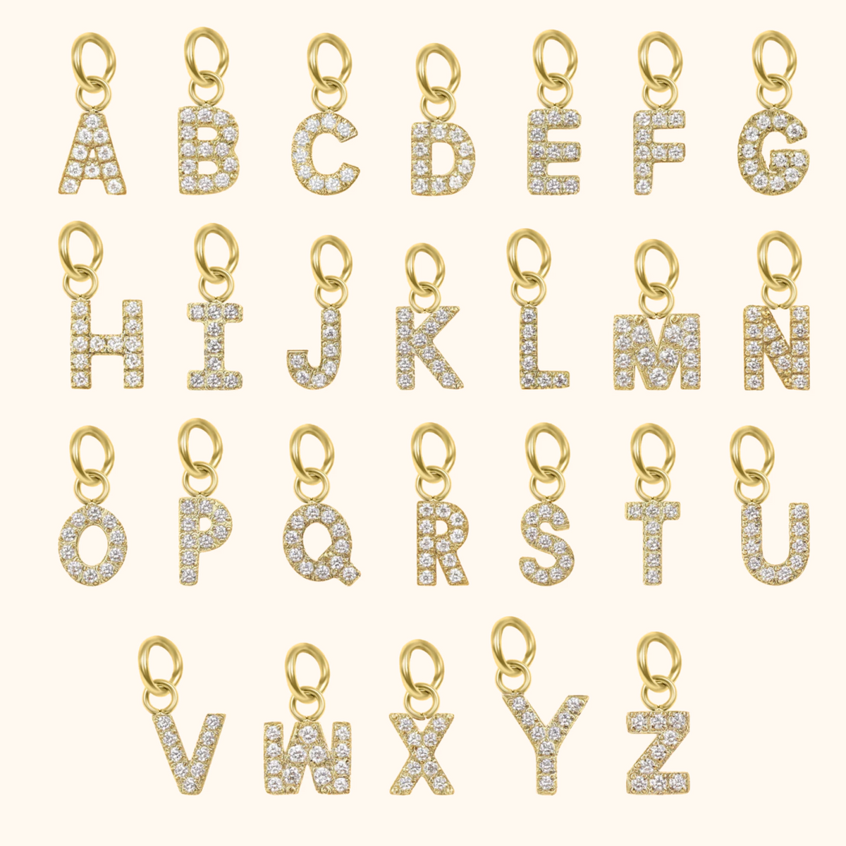 Gold letter pendants with diamonds on a white background
