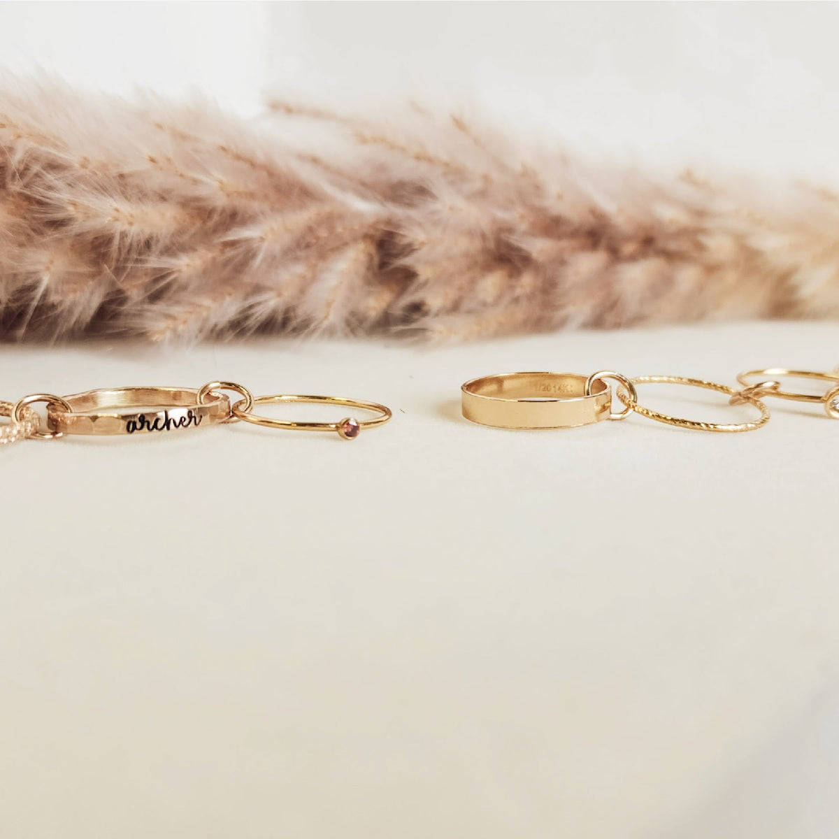 Gold bracelets on a white surface with a fur background