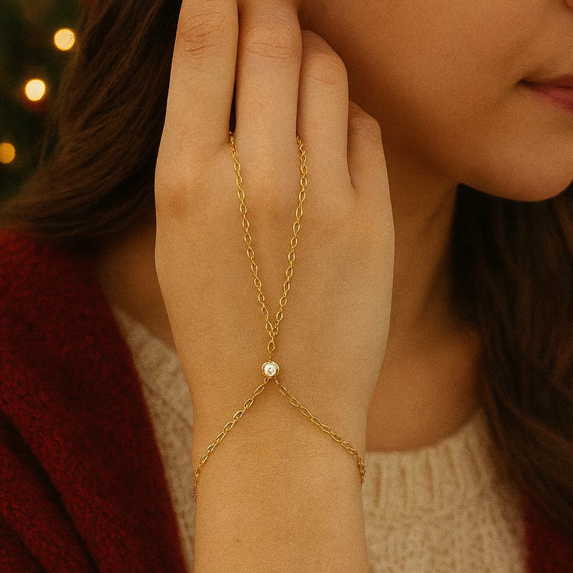 Gold hand chain with a cz on a blurred background