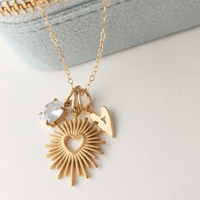 Golden Heartburst Charm Necklace with three gold-plated charms