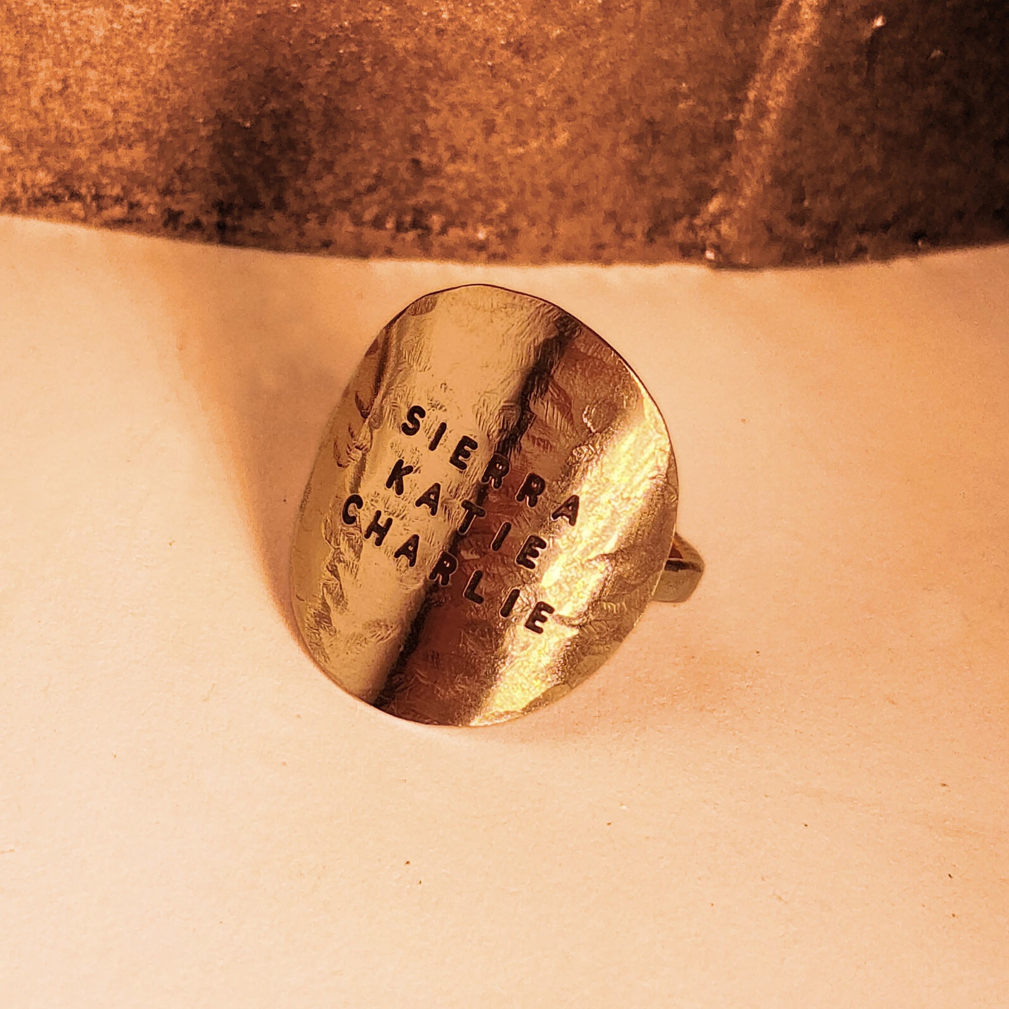 Detailed close-up of hand-stamped 14K gold filled disc ring showing hammered texture