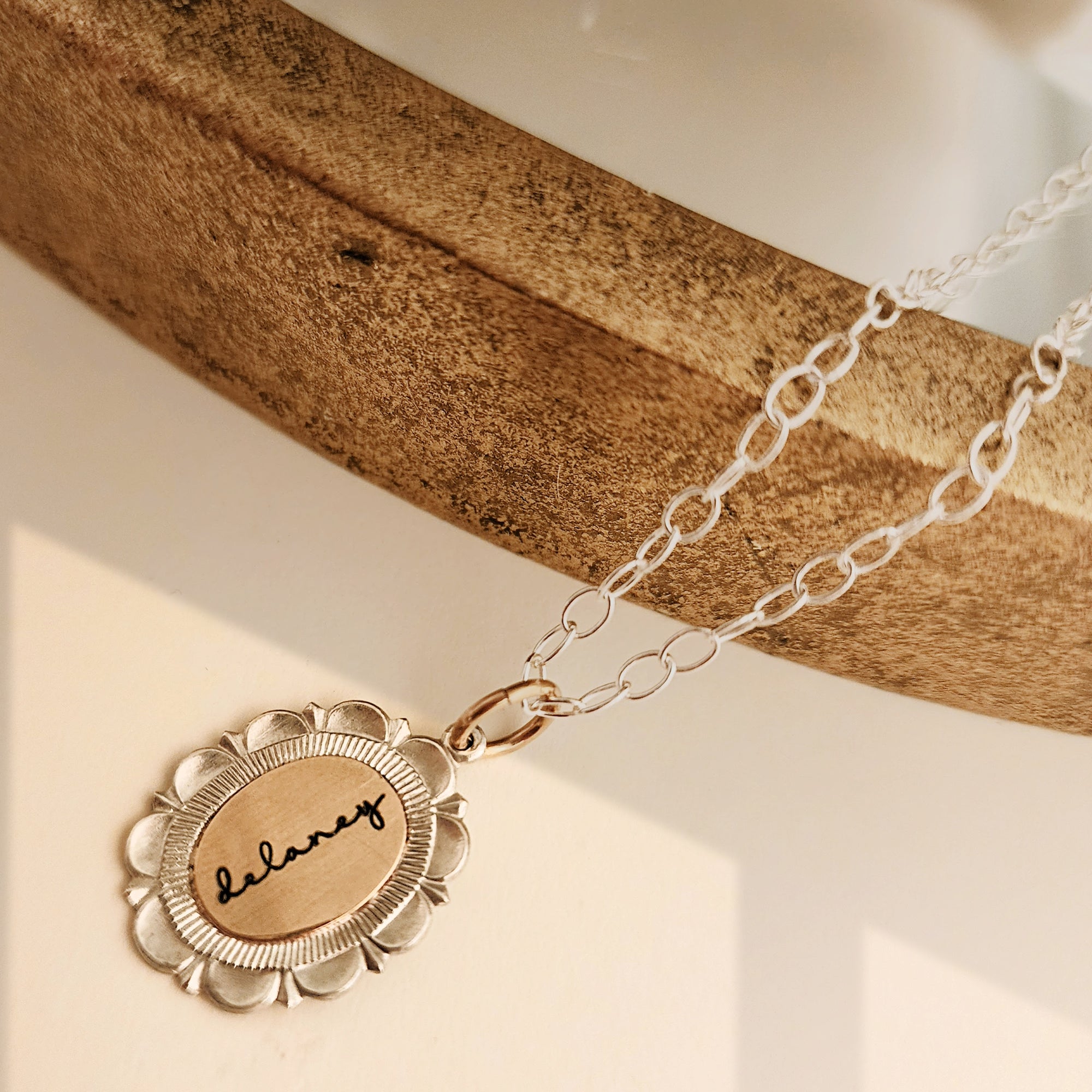Necklace with a gold pendant on a wooden surface