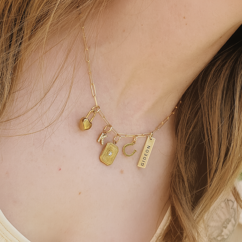 Gold necklace with various charms on a person's neck