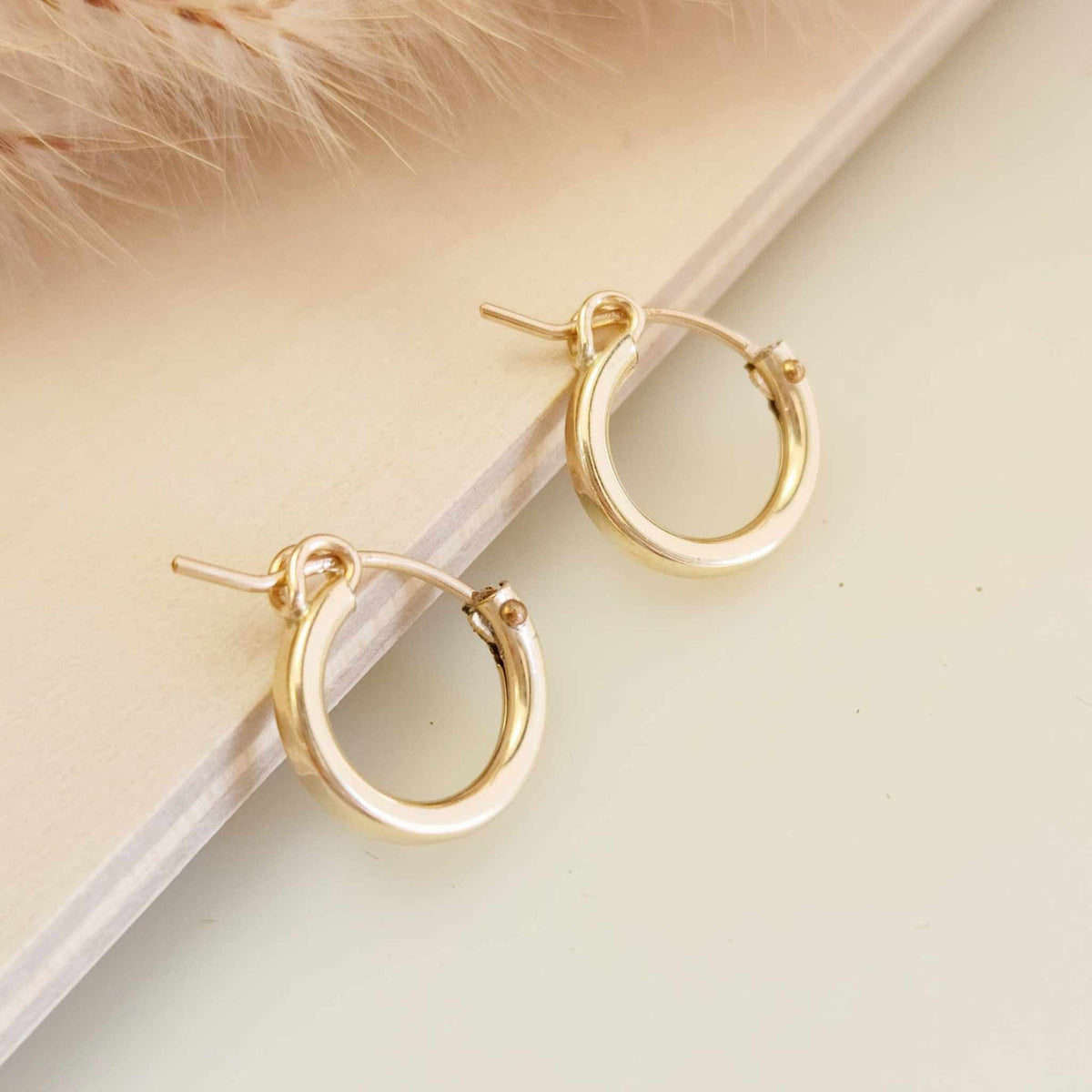 Lightweight gold and silver hoop earrings in three sizes
