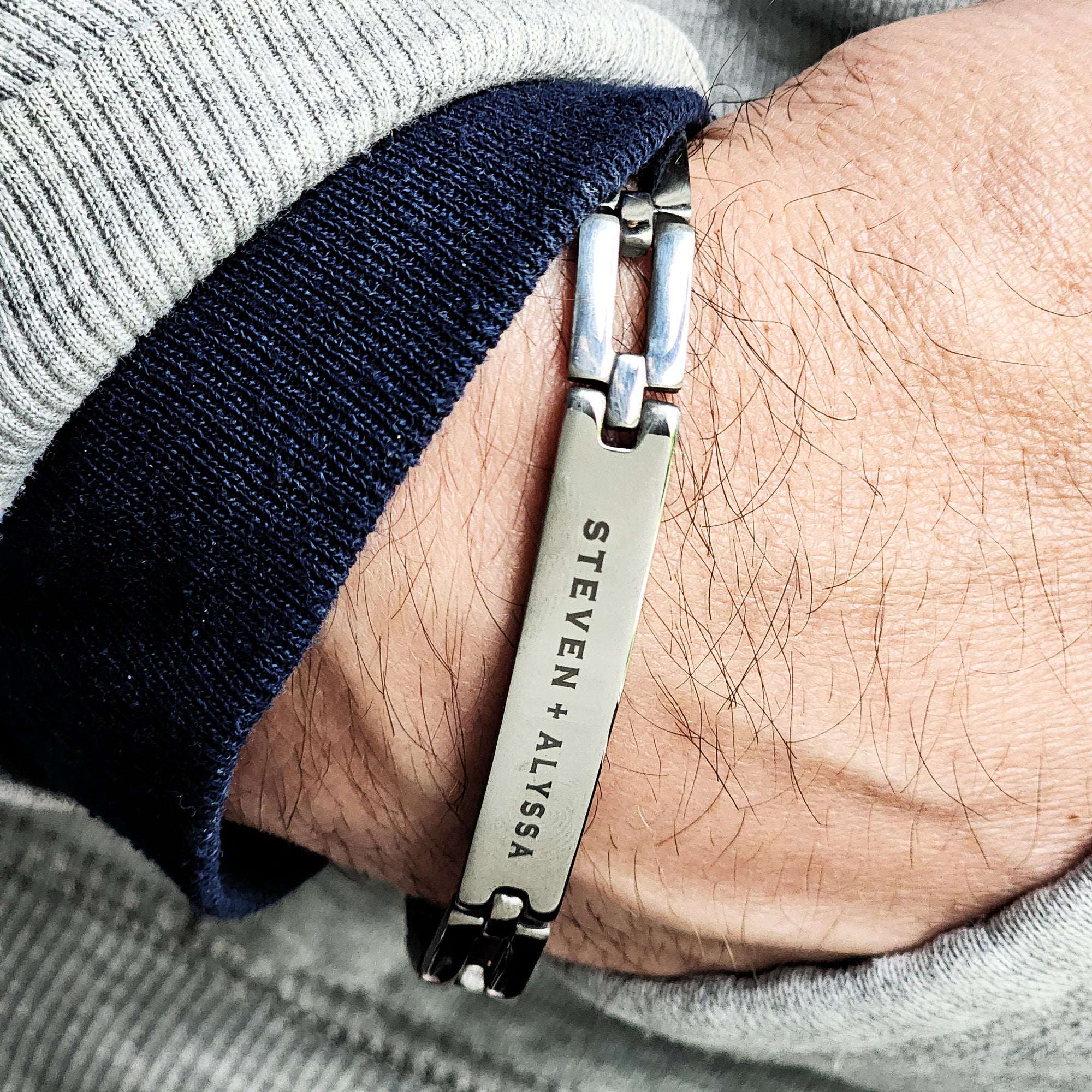 Bracelet with engraved names worn on wrist