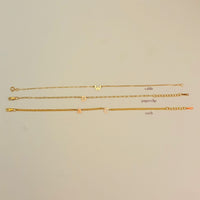 Three gold chains labeled 'cable', 'paperclip', and 'curb' on a beige background
