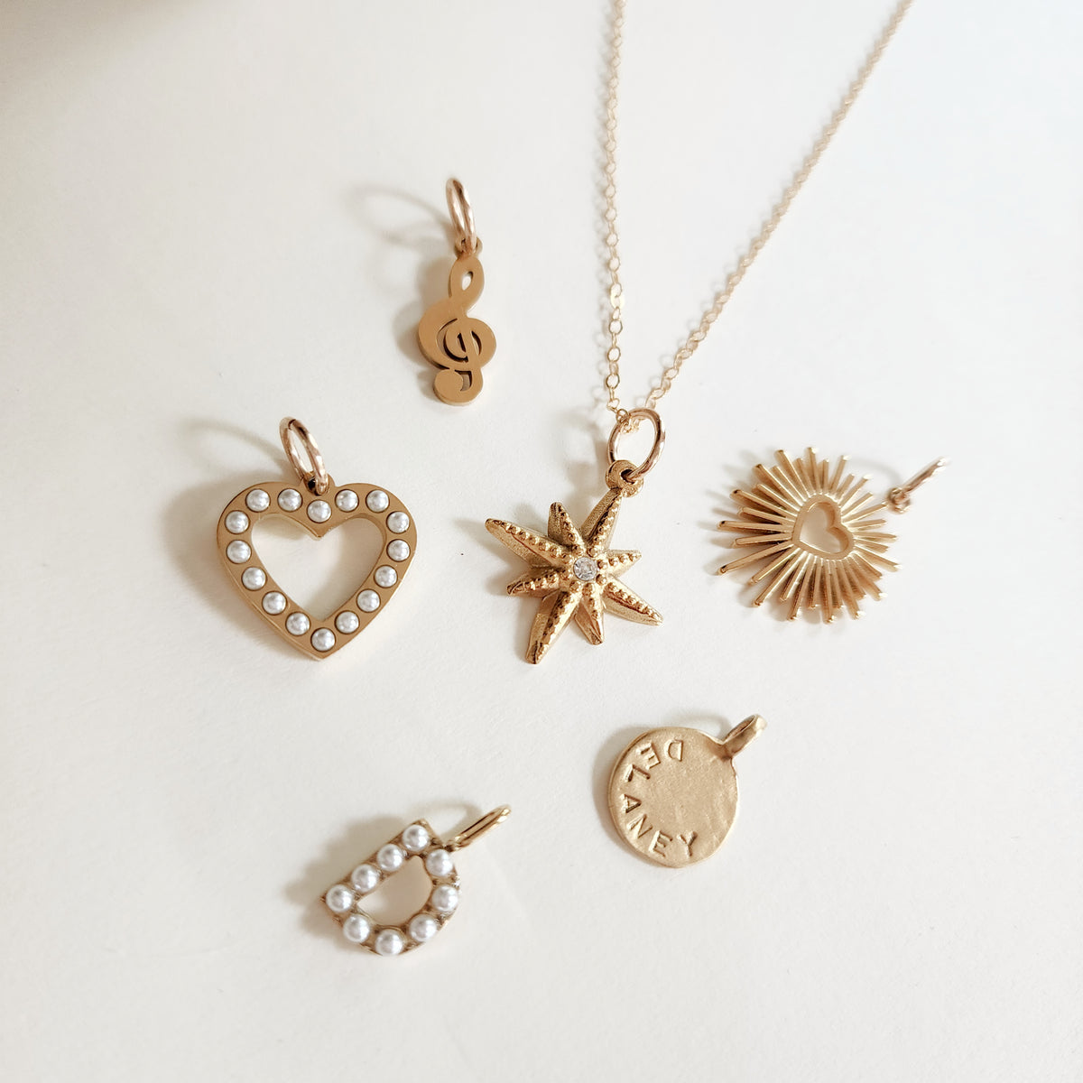 18k gold plated PVD add-on charms displayed with Going Golden gift boxes and packaging