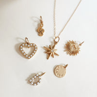 18k gold plated PVD add-on charms displayed with Going Golden gift boxes and packaging
