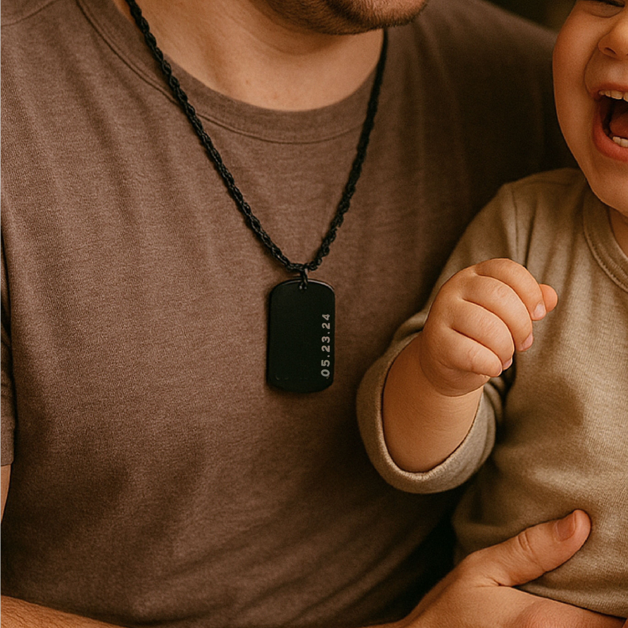 Man wearing a necklace with a dog tag, holding a child's hand.
