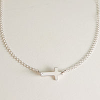 Sterling silver personalized cross necklace with blank engraving space on white background