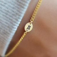Engraved '28 gold chain close up