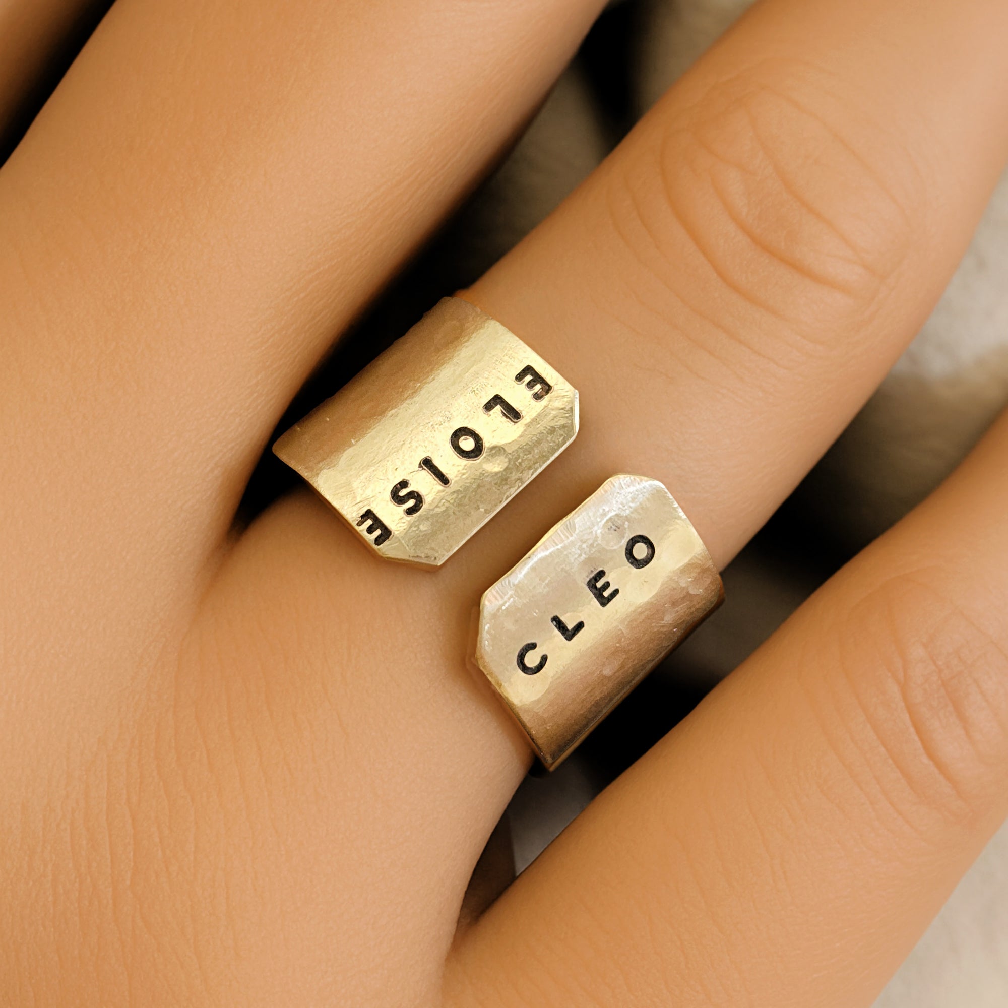 Gold ring with &#39;Cleo&#39; and &#39;ELOISE&#39; engraved on a finger