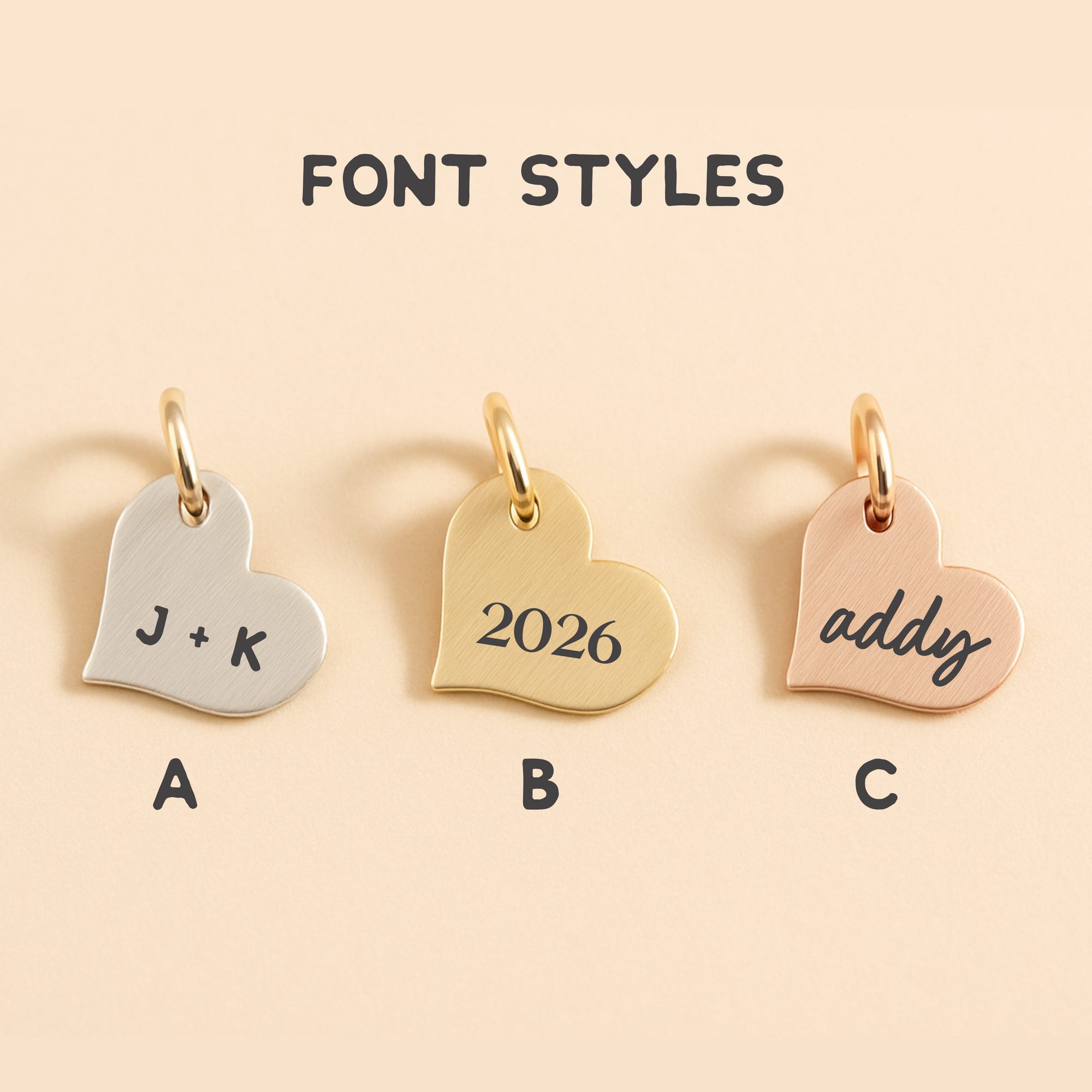 Three heart-shaped charms with different font styles on a beige background